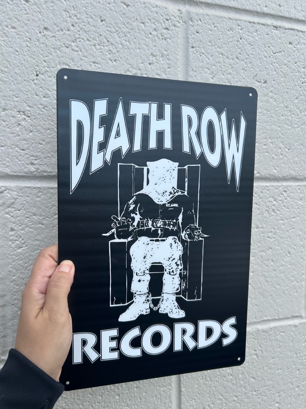 black metal wall sign featuring the classic white Death Row Records electric cha